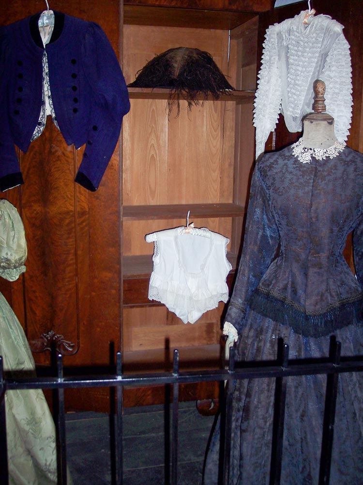 Interior of Sanchez Adobe in Woodside with period clothing and furniture from 1800s