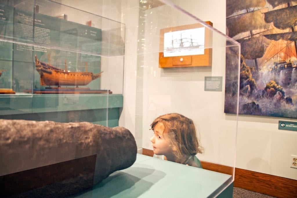 Child looking at Ships of the World exhibit at the San Mateo County History Museum