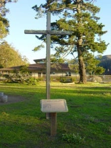 Sanchez Adobe field with large wooden cross in foreground
