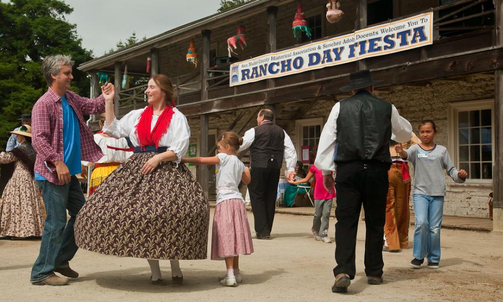 Guests dance in period costumes at the Sanchez Adobe Rancho Day Fiesta