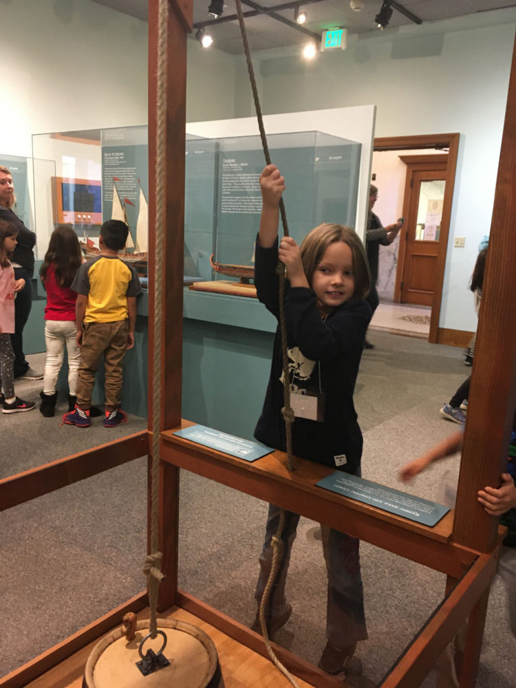 A young student plays with an interactive exhibit in Ships of the World at the San Mateo County History Museum