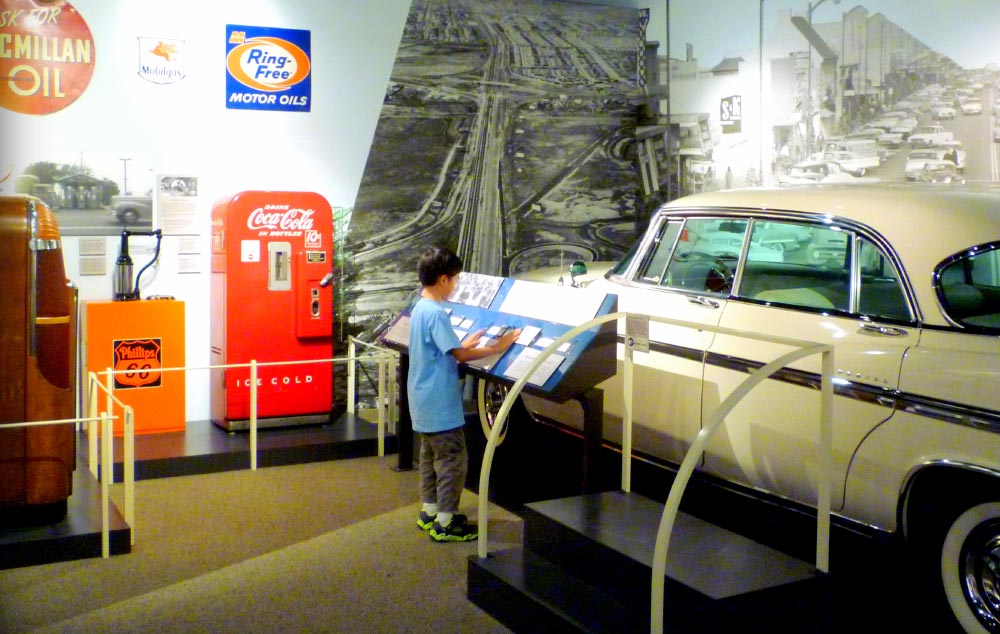 A young boy views a display at Journey to Work at the San Mateo County History Museum