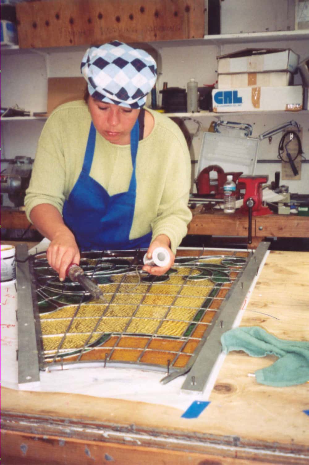 An artisan restores a stained glass section of the San Mateo County Courtroom A