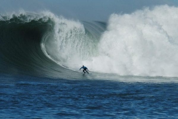 Grant Washburn surfing a huge wave at Mavericks in California