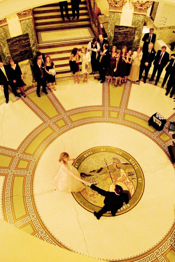 A bride and groom dance in the rotunda of the San Mateo County History Museum