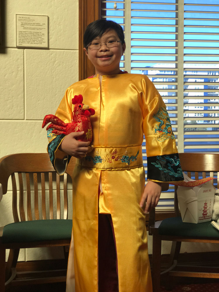 A young boy dressed in traditional Chinese dress for Lunar New Year celebrations at the San Mateo County History Museum