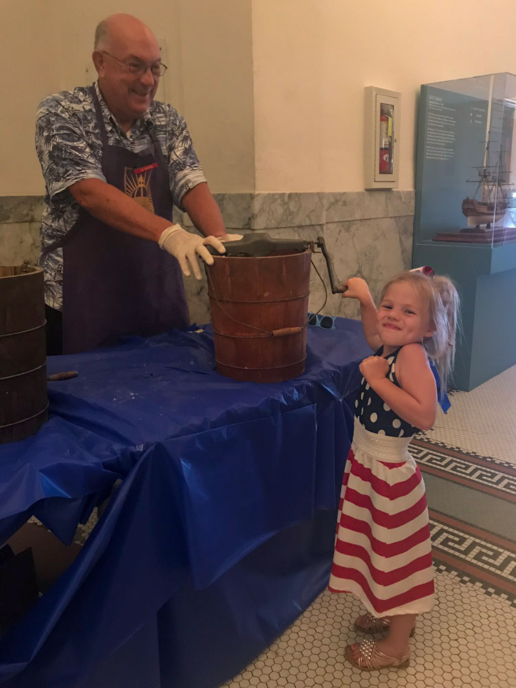 A young girl making handmade ice cream at an Old Fashioned Fourth at the San Mateo County History Museum