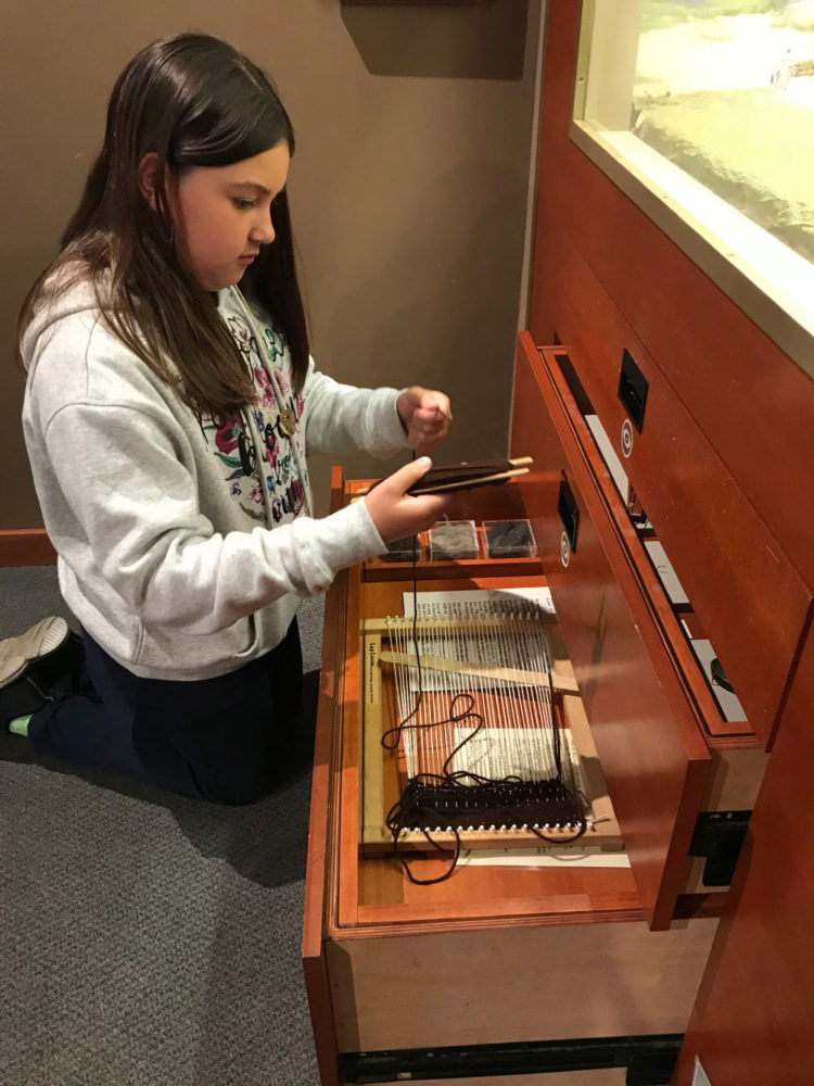 Young girl explores an interactive display at Providing Plenty school program at the San Mateo County History Museum