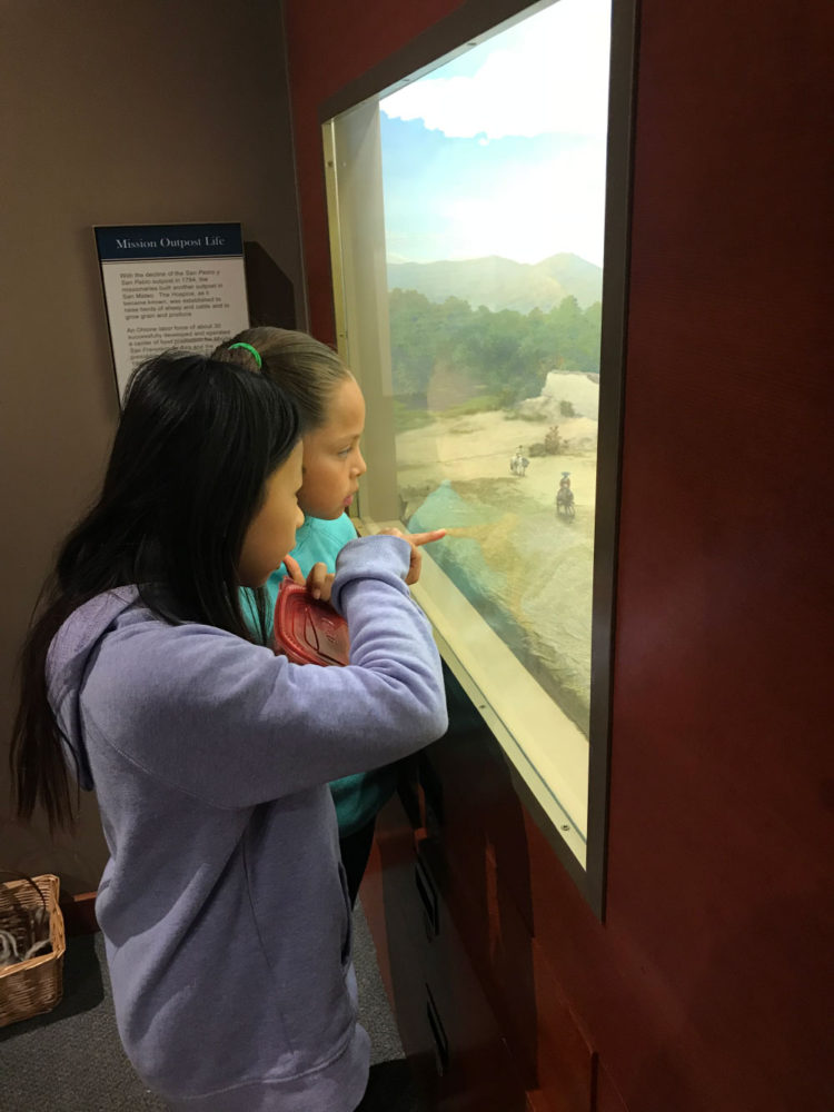 Two students view a display at Providing Plenty school program at the San Mateo County History Museum