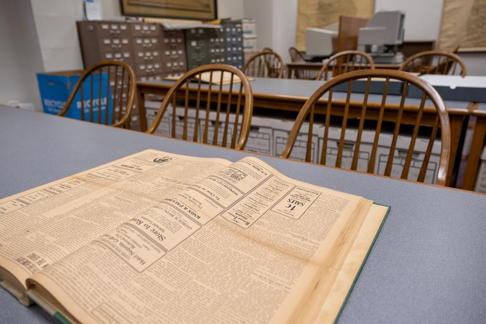 Archives desk at the San Mateo County History Museum with old newspaper articles displayed