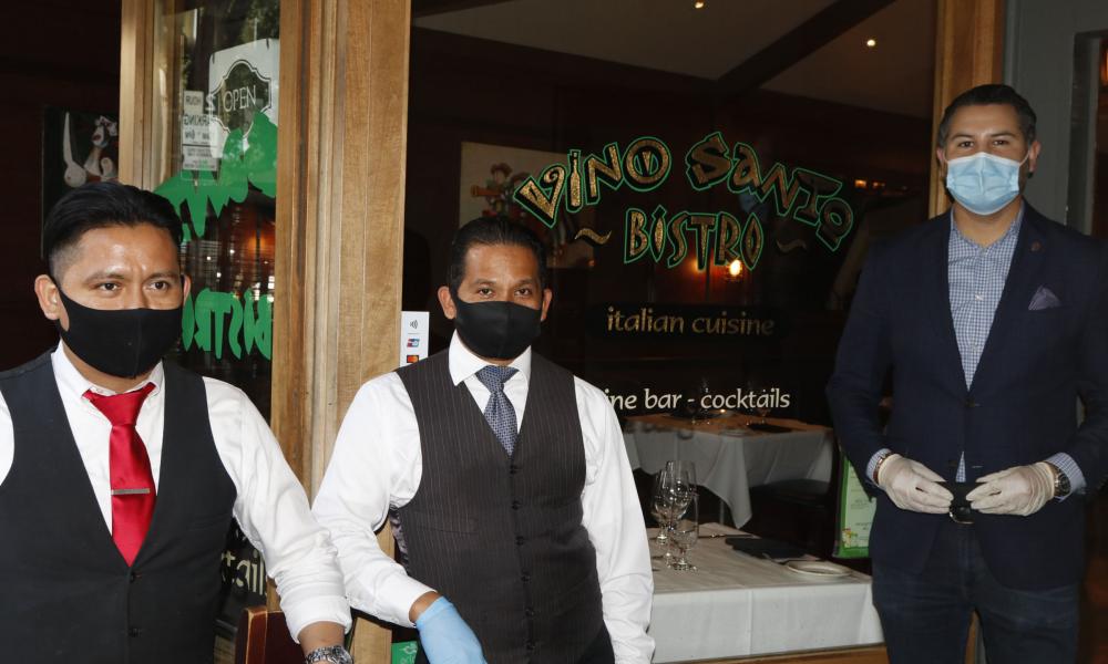 Staff of Vino Santo restaurant posing with COVID masks and gloves