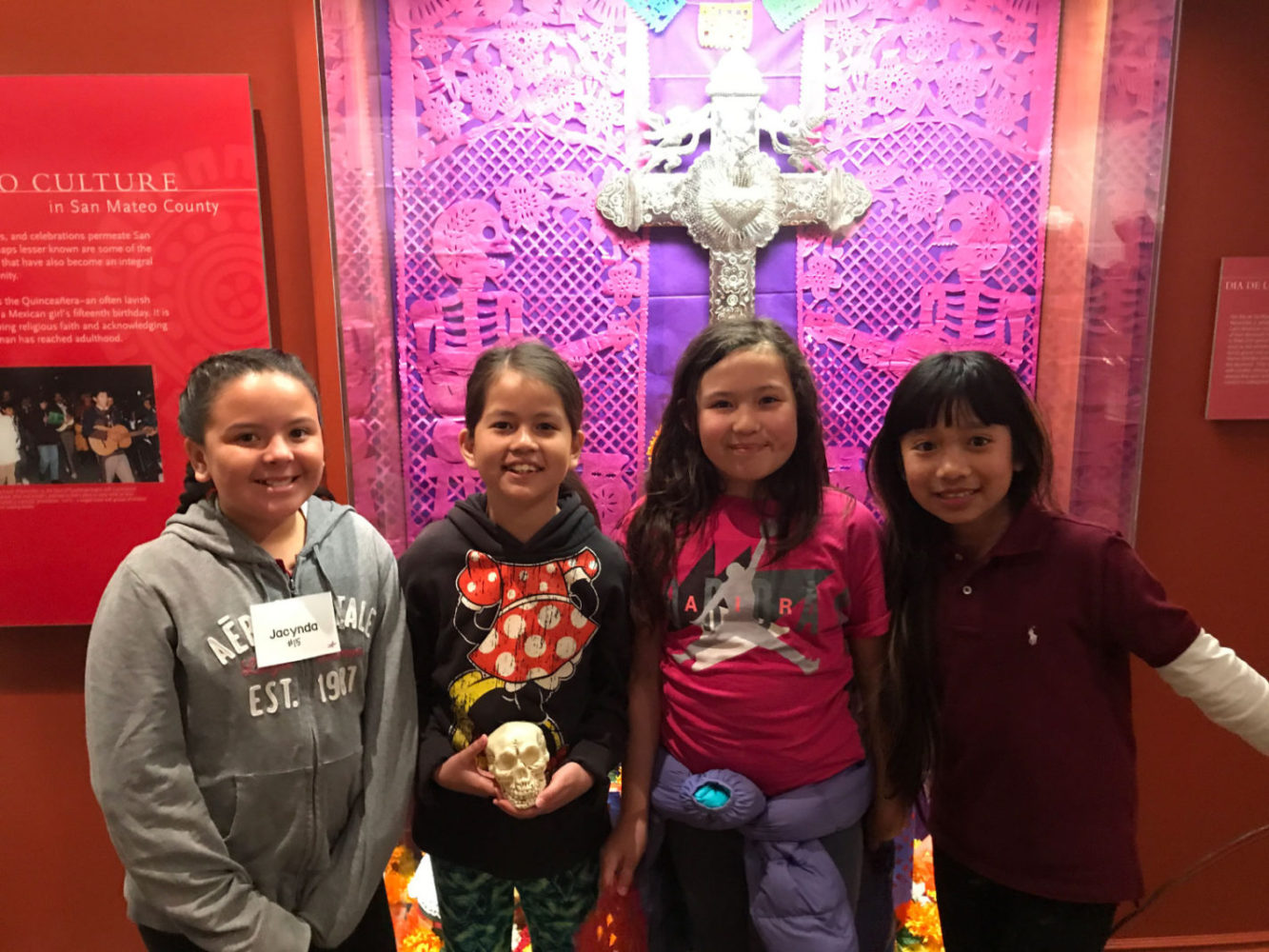 Students view an exhibit display the People from Many Places school program at the San Mateo County History Museum