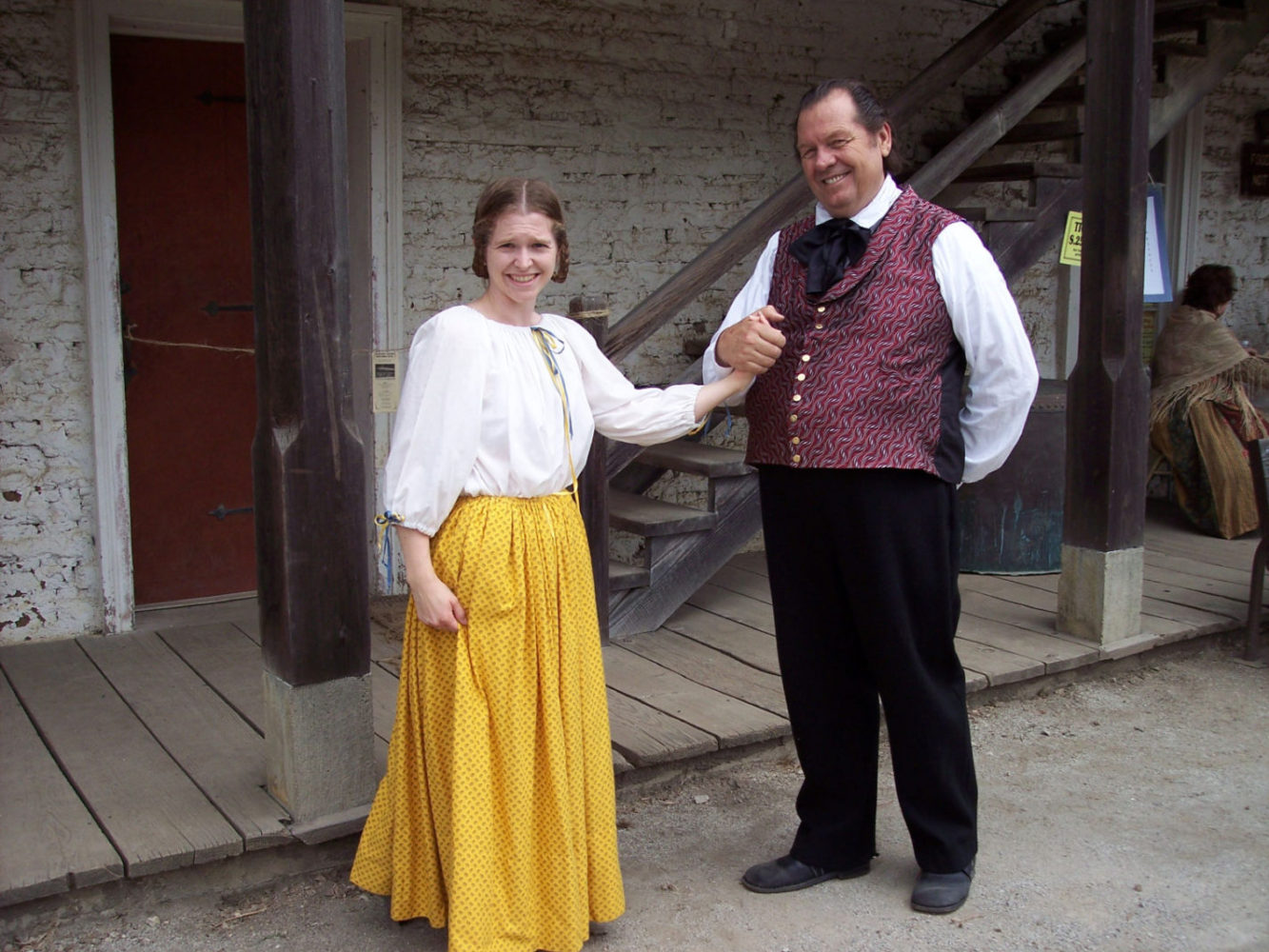 A young woman and man dressed in period costumes at the Sanchez Adobe Rancho Fiesta Day