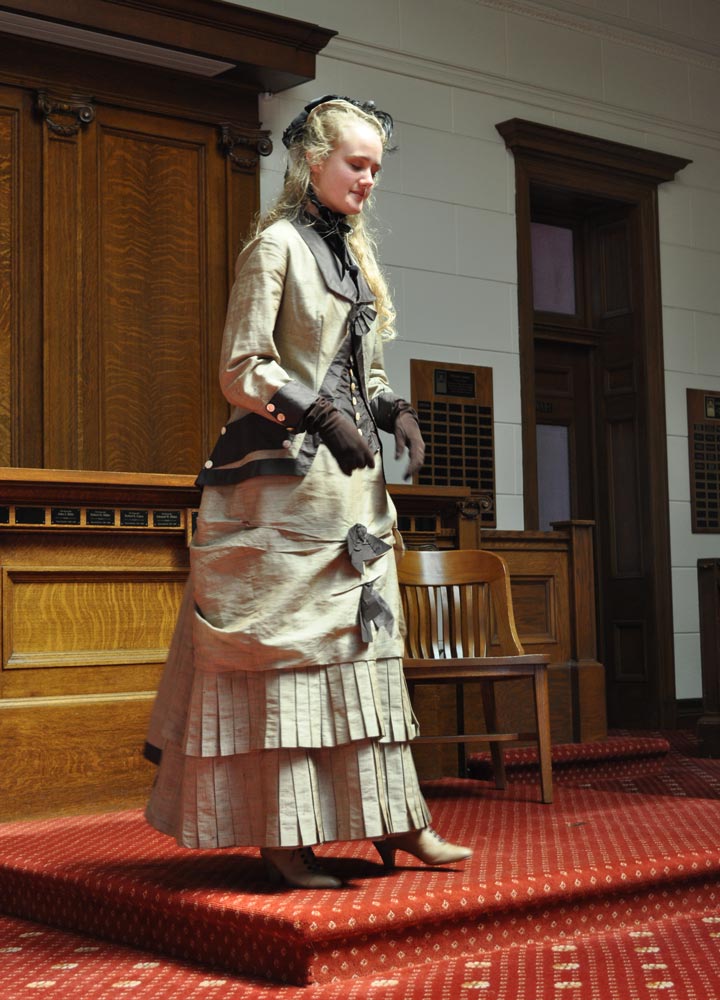 A young woman dressed in Victorian dress at San Mateo County History Museum