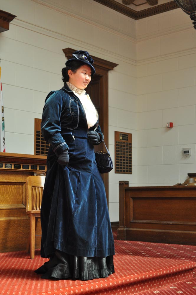 A young woman dressed in Victorian dress at San Mateo County History Museum