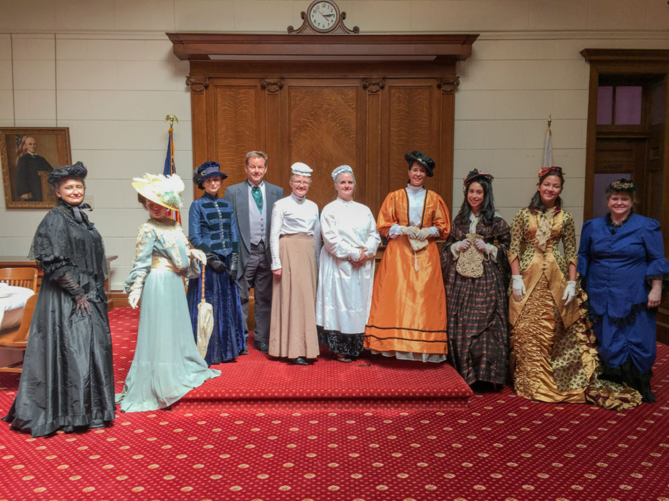 A group of people dressed in Victorian dress at San Mateo County History Museum