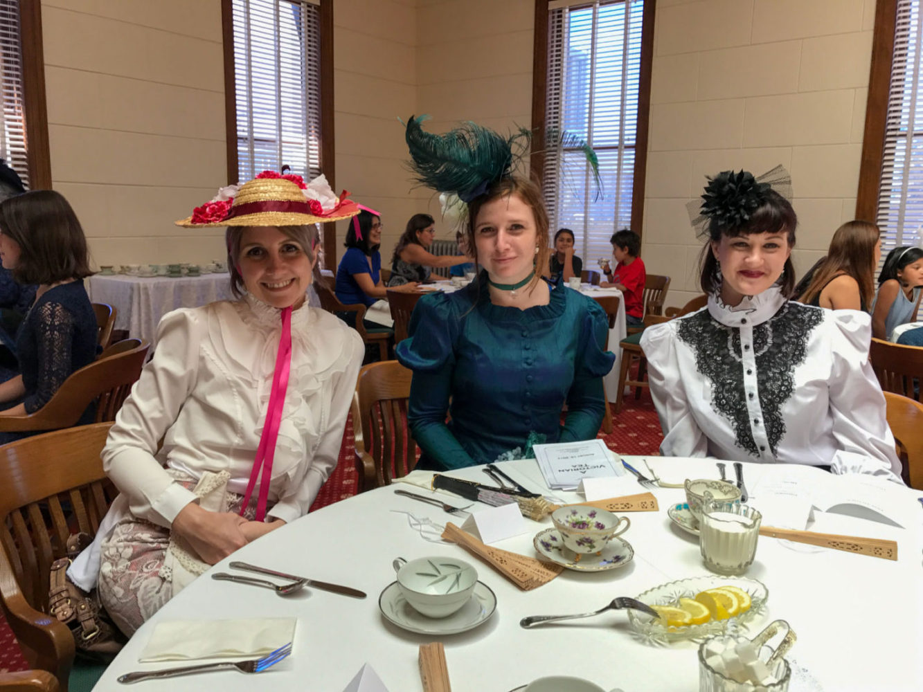 Three women dressed in Victorian dress at San Mateo County History Museum