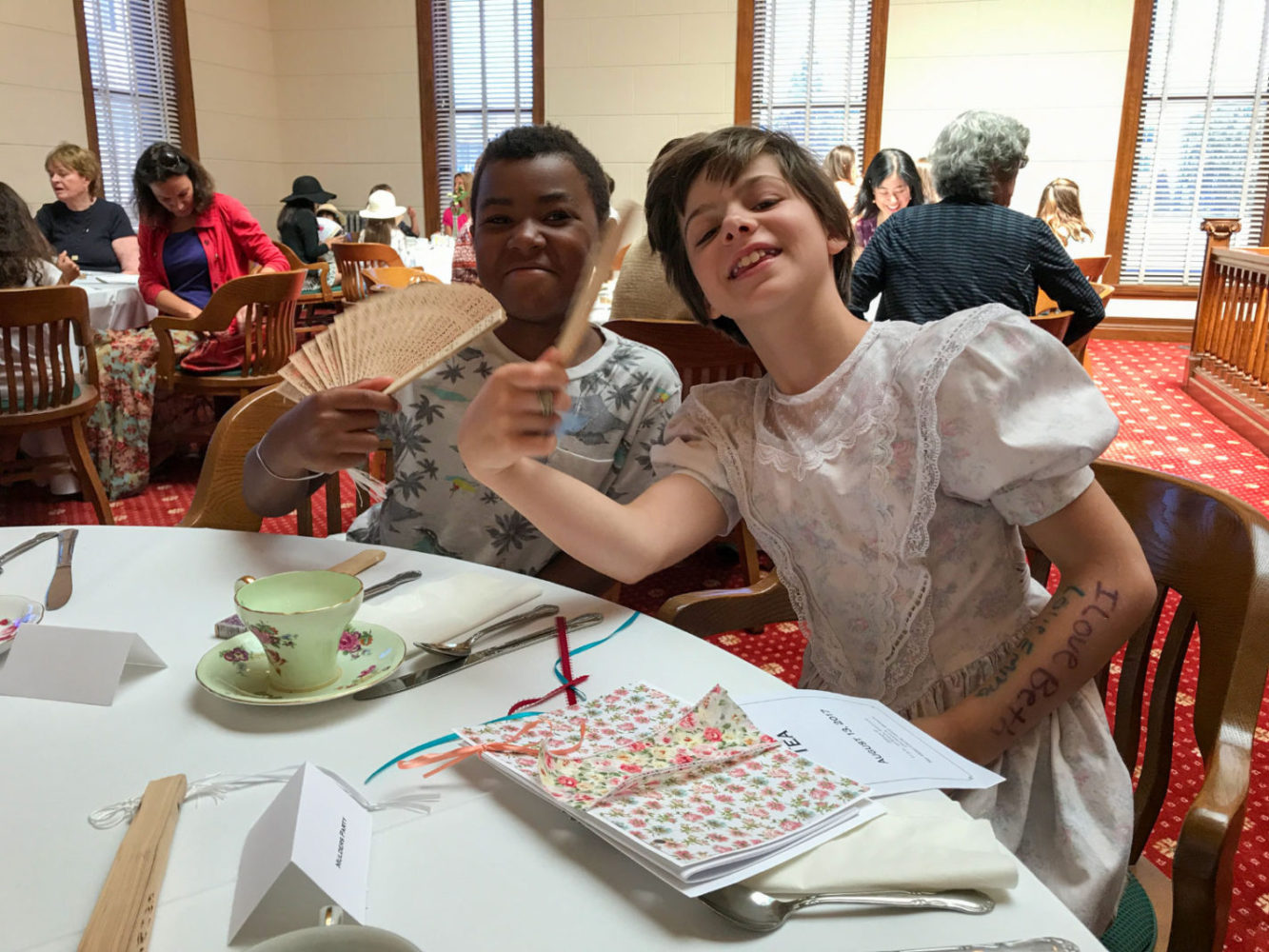 Two young visitors enjoy afternoon tea at Victorian Days at San Mateo County History Museum
