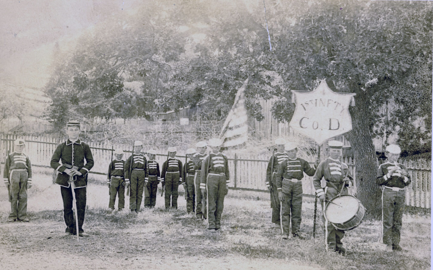 Young boys dressed in uniforms with toy rifle, fife and drum from the First Infantry Company D circa 1880s
