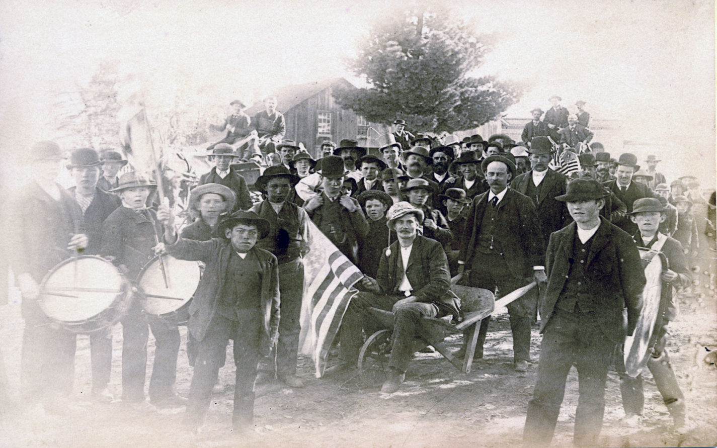 Group of men and boys with flags and drums circa 1880s