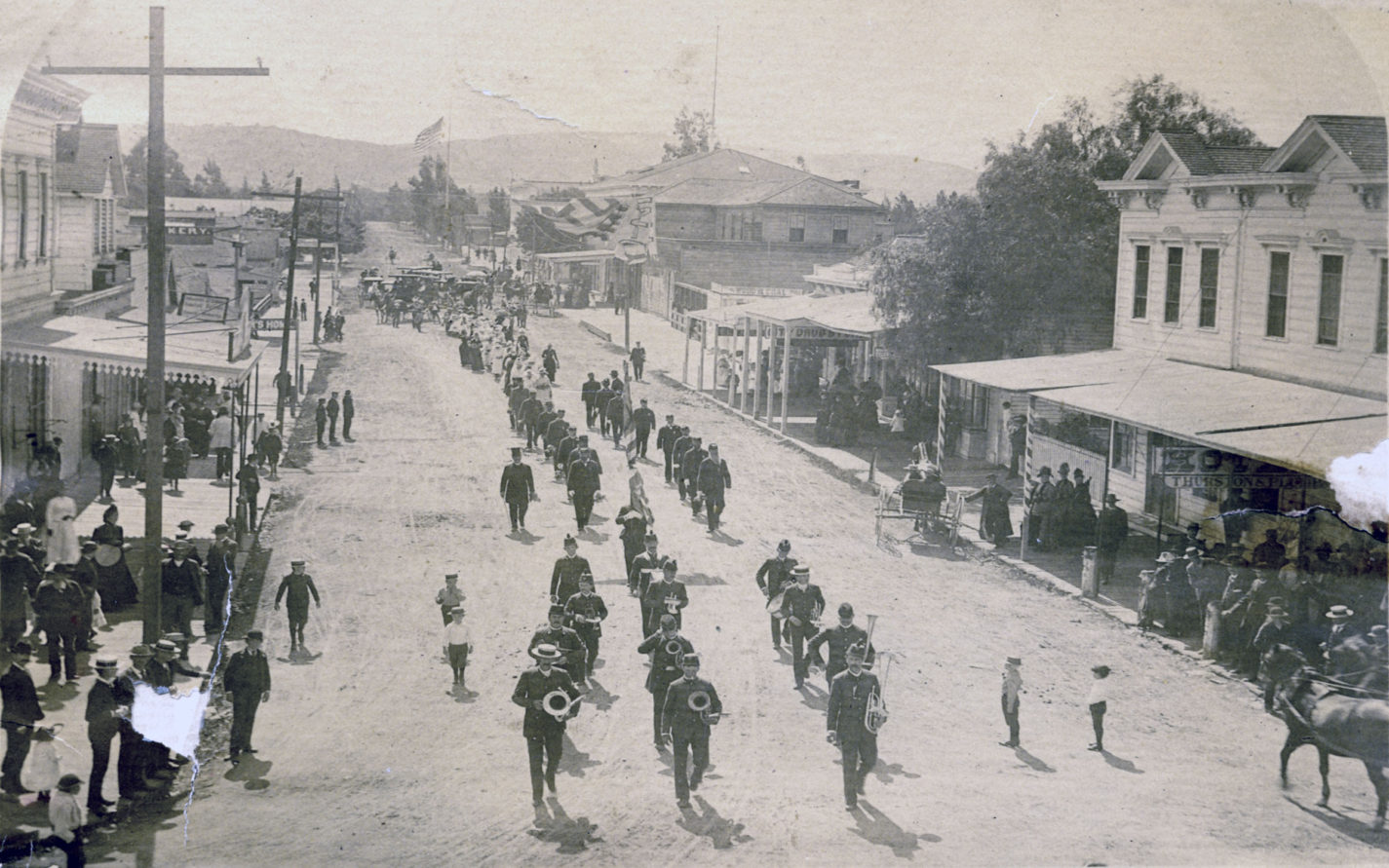 Band marches on Redwood City street during a Fourth of July parade circa 1880s