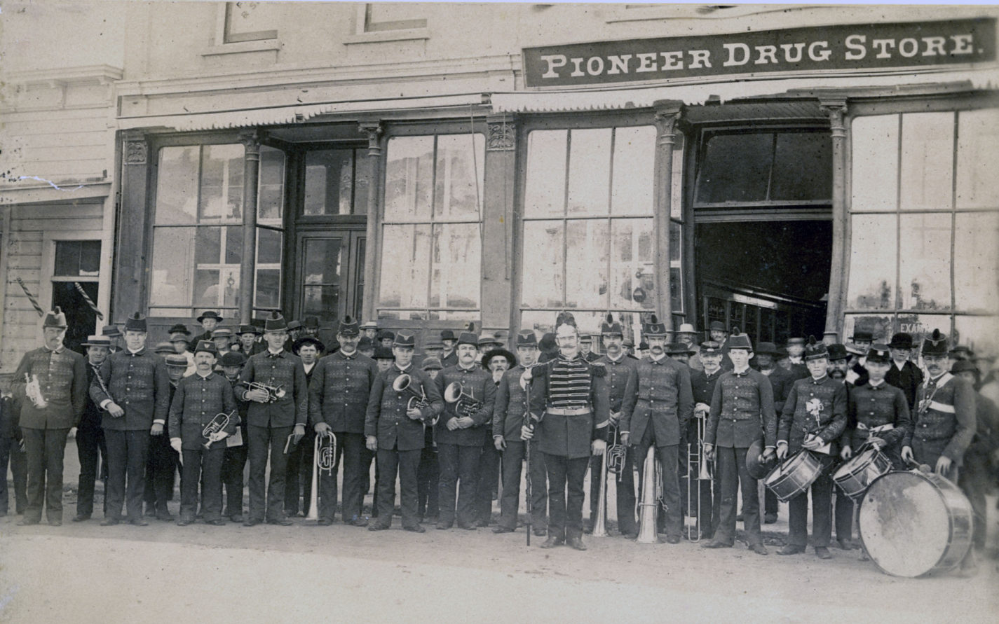 Marching band in front of the Pioneer Drug Store in Redwood City circa 1880s