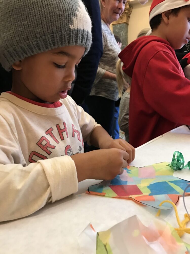 Young boy makes a Filipino parol for the holidays