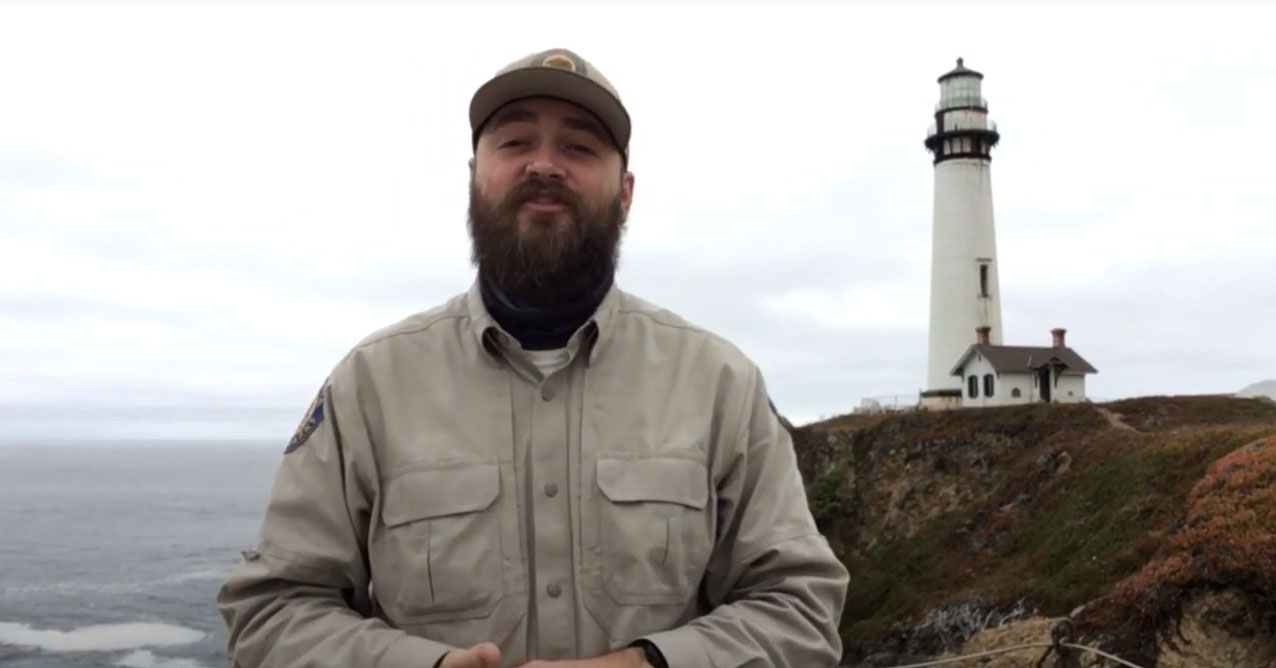 Male park ranger in front of the Pigeon Point Lighthouse