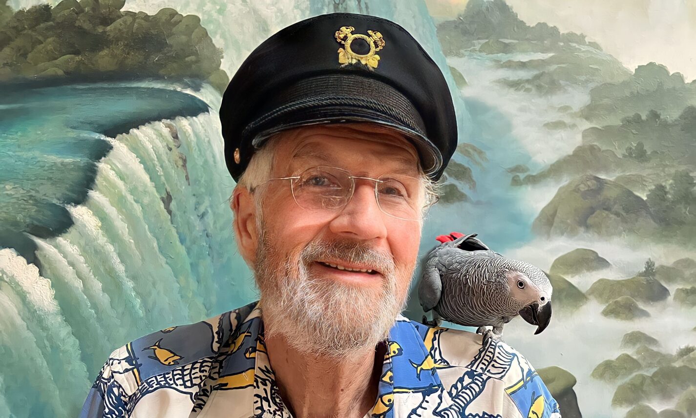 Jamis MacNiven with a bird on his shoulder