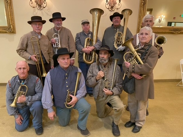 Nine performers in Civil War uniforms holding brass instruments