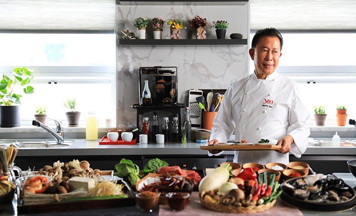 Chef Martin Yan in a kitchen with ingredients