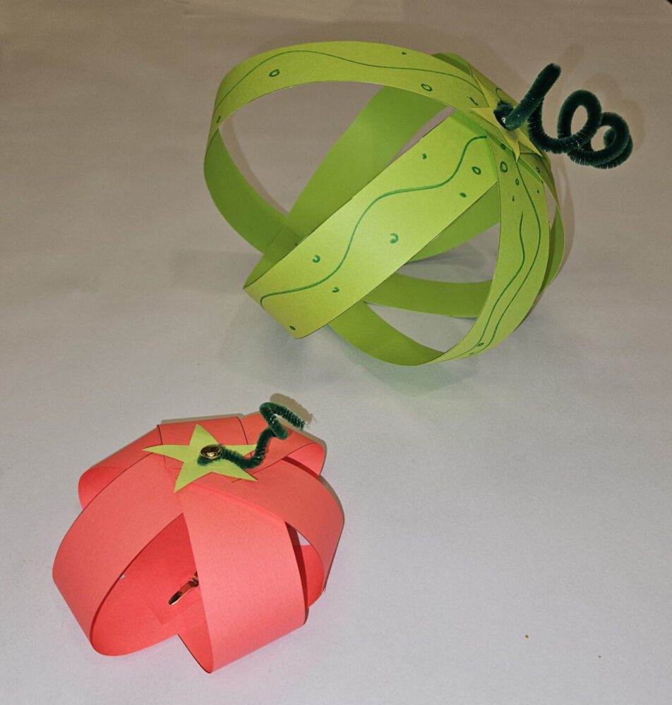 Three dimensional red tomato and green melon made out of strips of paper