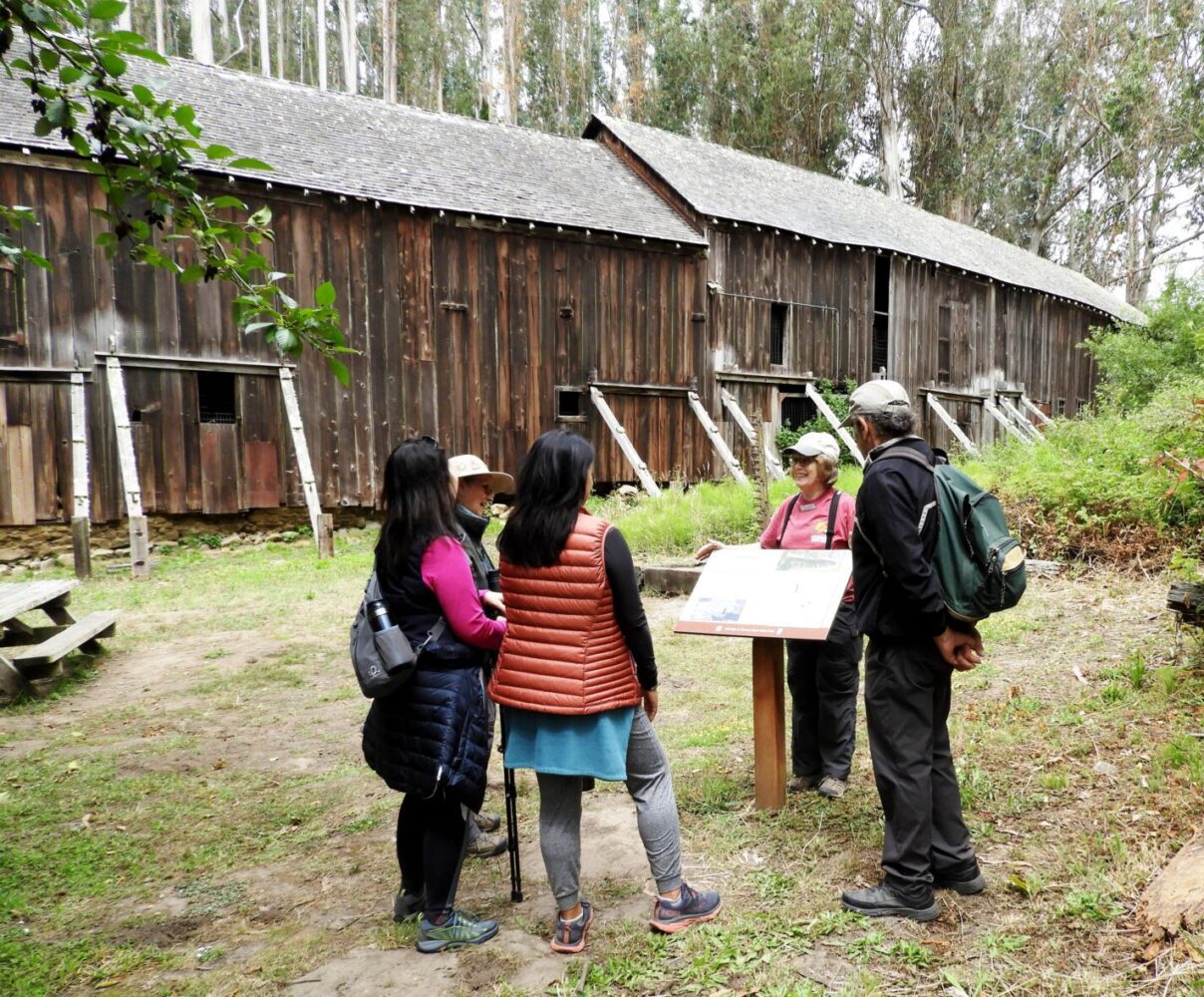 Tour group gathered at the Burleigh H Murray Ranch State Park with old building in background