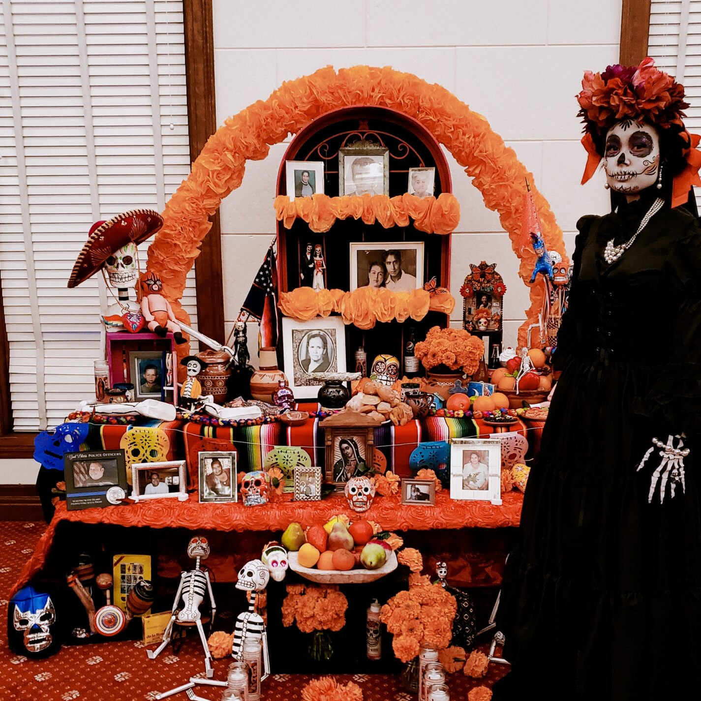 La Catrina by a Dia de los Muertos altar