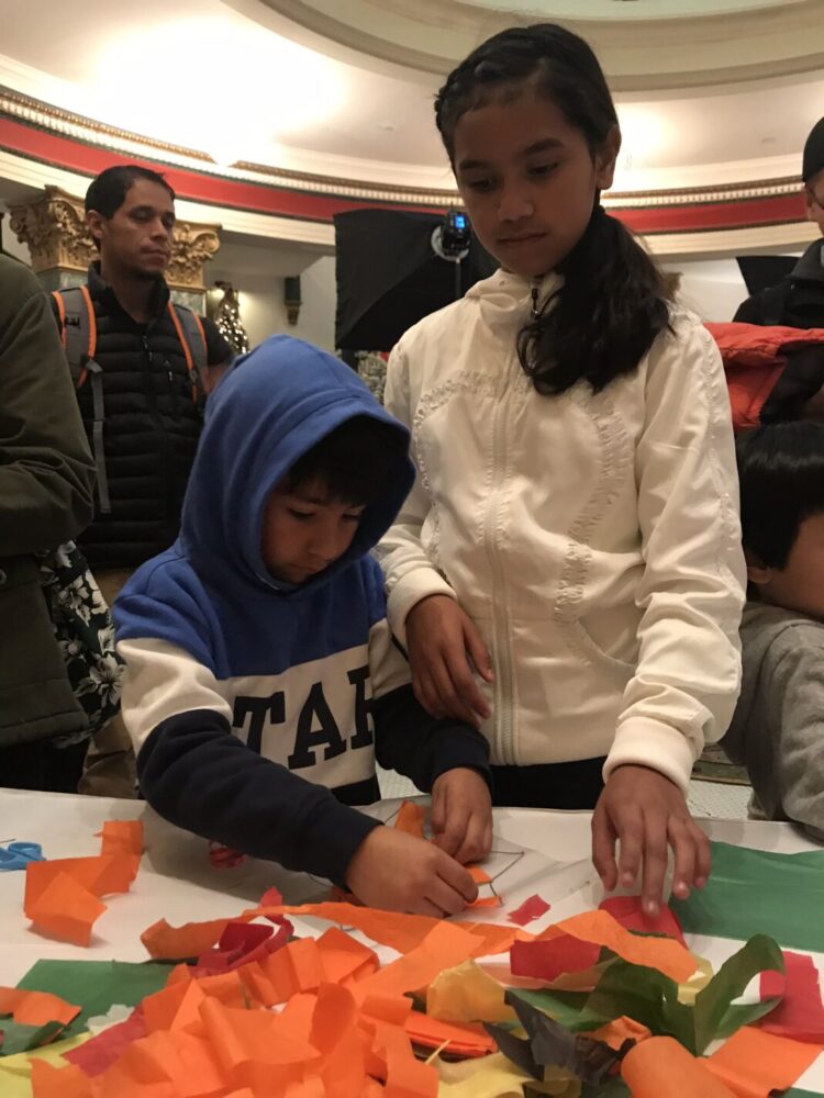 two children collaborate on a holiday craft together