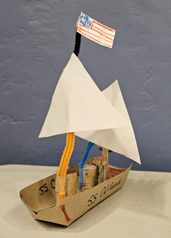 Model ship made out of corks, paper and pipe cleaners