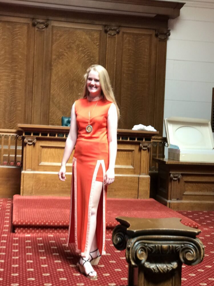 Woman wearing orange hot pants