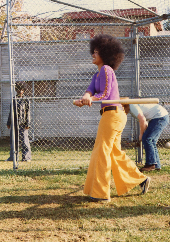 A girl playing baseball